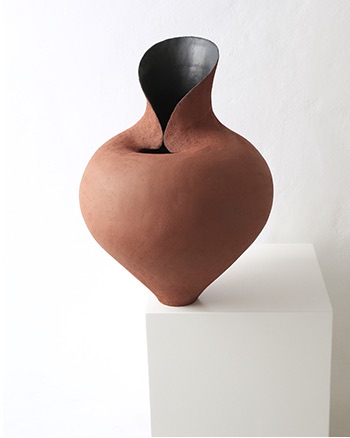 Warm terracotta open ceramic vessel with sculptural petal-like edges
